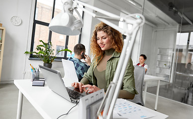 Image showing creative woman with laptop working at office