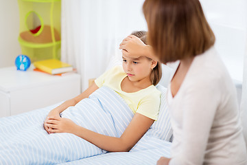 Image showing mother taking care of unhealthy daughter at home