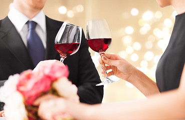 Image showing hands of couple clinking red wine glasses