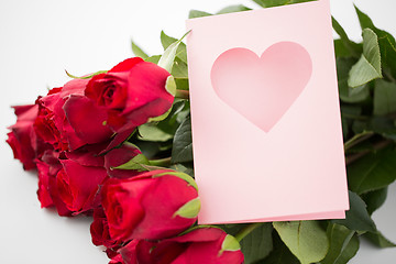 Image showing close up of red roses and greeting card with heart