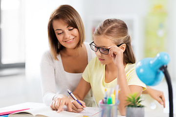 Image showing mother and daughter doing homework together