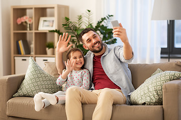 Image showing father and daughter taking selfie at home