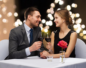 Image showing young couple with glasses of wine at restaurant