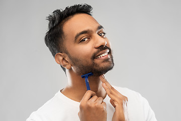 Image showing indian man shaving beard with razor blade