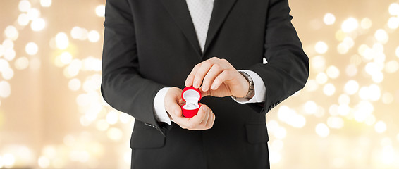 Image showing man with diamond engagement ring in red gift box