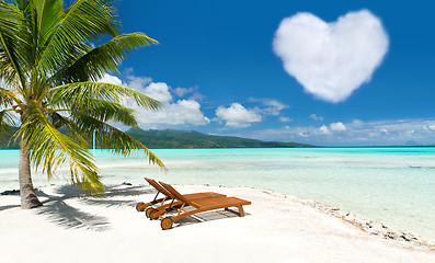 Image showing beach with two sunbeds and heart shaped cloud