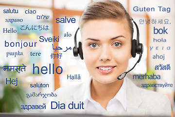 Image showing woman in headset over words in foreign languages