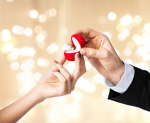 Image showing man giving diamond ring to woman on valentines day
