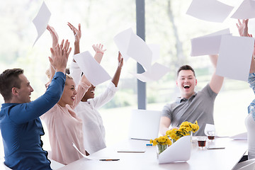 Image showing multiethnic startup Group of young business people throwing docu