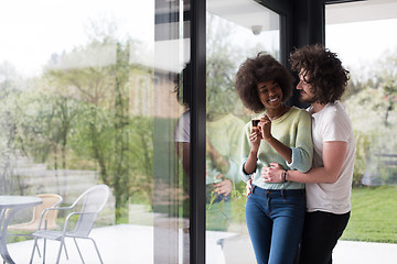 Image showing happy multiethnic couple relaxing at modern home indoors