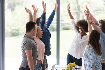 Image showing multiethnic startup Group of young business people celebrating s