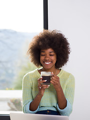 Image showing black woman in the living room on the floor