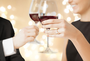 Image showing close up of engaged couple drinking red wine