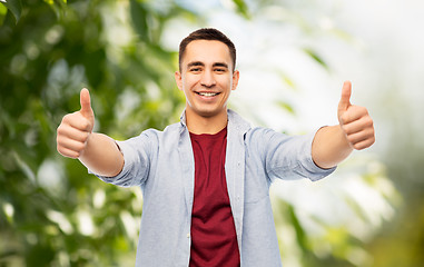 Image showing happy young man showing thumbs up