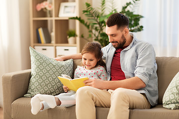 Image showing happy father and daughter reading book at home