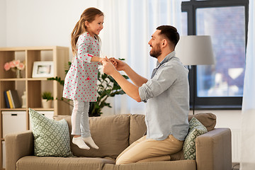 Image showing father and daughter jumping and having fun at home