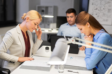 Image showing business team with laptop working late at office