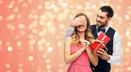 Image showing happy man giving woman surprise present