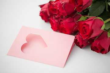 Image showing close up of red roses and greeting card with heart