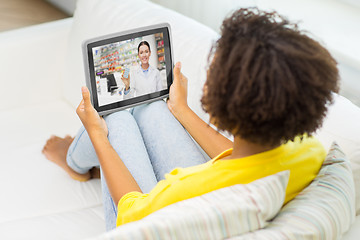 Image showing woman having video chat with pharmacist on tablet 