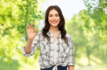 Image showing teenage girl showing ok over natural background