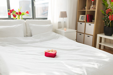 Image showing heart shaped gift box on bed at home bedroom 