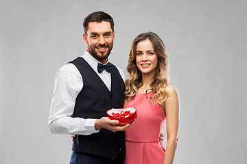 Image showing happy couple with chocolate box in shape of heart