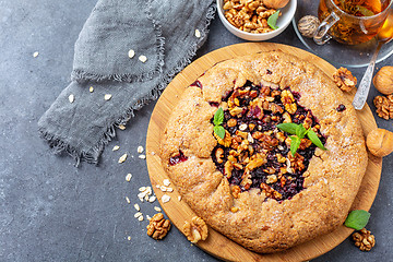 Image showing Galette pie with oat flakes, currant and walnuts.