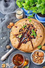 Image showing Green tea and Galette pie with black currants.