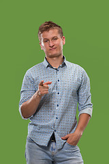 Image showing The overbearing businessman point you and want you, half length closeup portrait on green background.