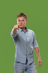 Image showing The overbearing businessman point you and want you, half length closeup portrait on green background.