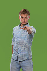 Image showing The overbearing businessman point you and want you, half length closeup portrait on green background.