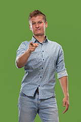 Image showing The overbearing businessman point you and want you, half length closeup portrait on green background.