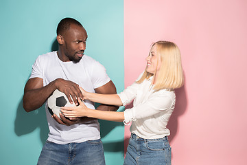 Image showing The unhappy and angry fans on colored blue and pink background.