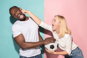 Image showing The unhappy and angry fans on colored blue and pink background.