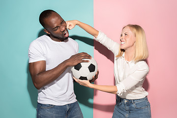 Image showing The unhappy and angry fans on colored blue and pink background.