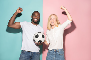 Image showing The young fans celebrating on blue and pink trendy colors.