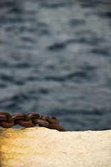 Image showing Old and rusty mooring post