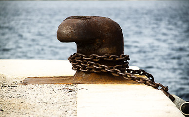 Image showing Old and rusty mooring post