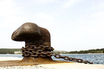 Image showing Old and rusty mooring post