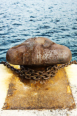 Image showing Old and rusty mooring post