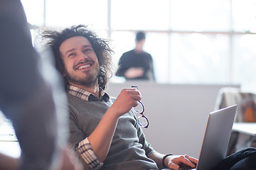 Image showing businessman working using a laptop in startup office