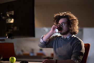 Image showing Tired businessman working late