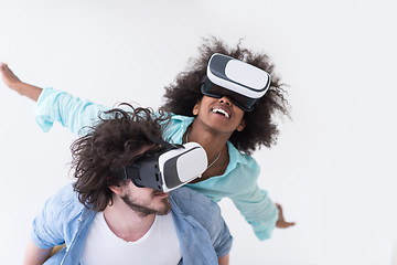 Image showing multiethnic couple getting experience using VR headset glasses