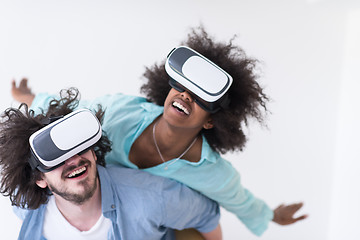 Image showing multiethnic couple getting experience using VR headset glasses