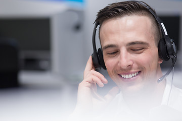 Image showing male call centre operator doing his job