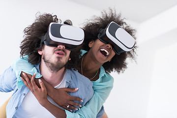 Image showing multiethnic couple getting experience using VR headset glasses