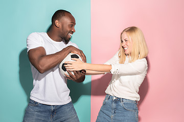 Image showing The unhappy and angry fans on colored blue and pink background.