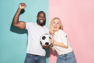 Image showing The young fans celebrating on blue and pink trendy colors.