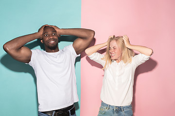 Image showing We won. Winning success happy afro man and woman celebrating being a winner. Dynamic image of caucasian female and male model on pink studio.